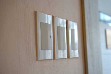 Household light switch on the wall. White plastic switch.