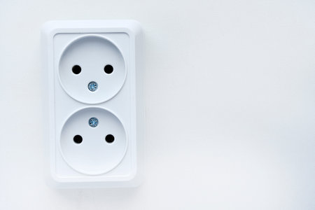 White double electrical outlet on a white background. Eurozette close-up. electrical appliance.