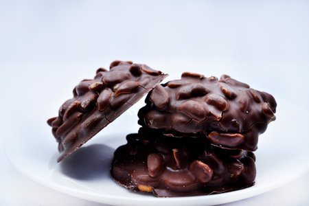 Chocolate chip cookies with nuts. Sweet appetizer on a white plate.の写真素材