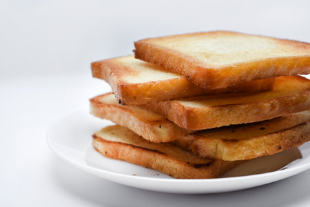Fried toast on a white plate. Baked bread for sandwiches. Vegan food.の写真素材