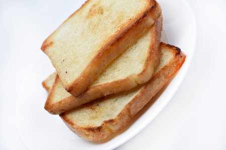 Fried toast on a white plate. Baked bread for sandwiches. Vegan food.