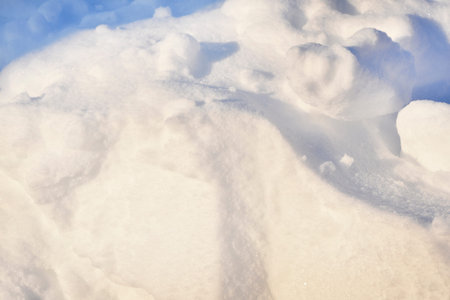 Lumps of snow in winter. Snow and light during the day. Snowdrifts.