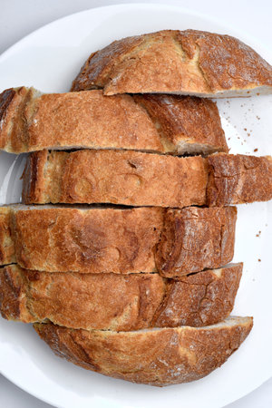 Fresh crusty bread. Sliced bread on a plate. Sandwiches.