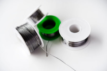 Tin-lead solder in coils on a white background. Materials for soldering.