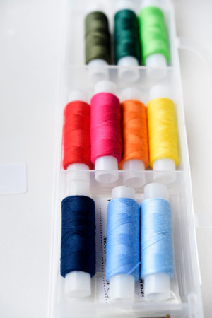 Multicolored skeins of thread in the set. The threads are in a plastic box.の写真素材