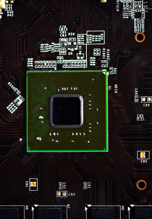 A brown printed circuit board with a processor chip and video memory strips. Electronic components...