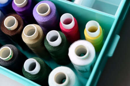 A set of colorful sewing threads. Skeins of thread in a plastic box.の写真素材