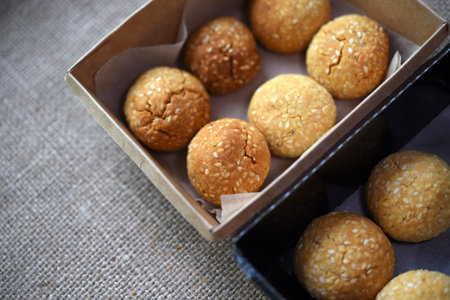 Sweet sesame cookies in cardboard boxes on burlap. Cookies in a box.