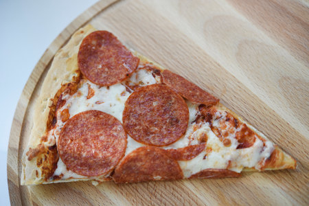 Meat pizza on a wooden stand. Delicious Italian pizza.の写真素材