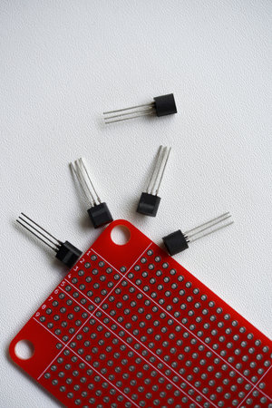 Red printed circuit board and chips and radio components. Capacitors and transistors.