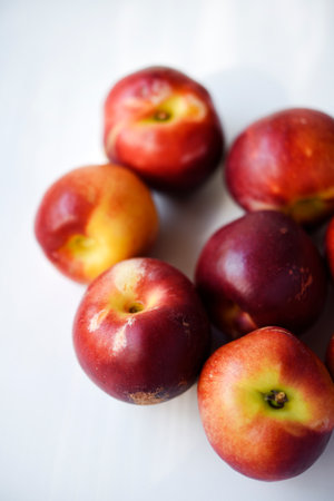 Red and yellow plums on a white background.の写真素材