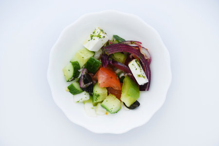 Juicy fresh salad in a bowl. Cucumbers, tomatoes and olives.の写真素材