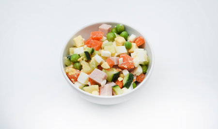 Vegetable salad with meat and sauce in a white salad bowl. A small snack.の写真素材