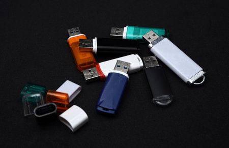 USB flash drives on a black background. The information carrier. Several flash drives.