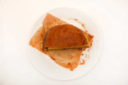 Cheeseburger on a white background. Meat burger cut into slices.