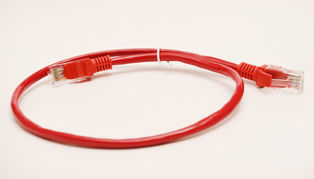 Red internet cable on a white background. The RJ-45 connector.の写真素材