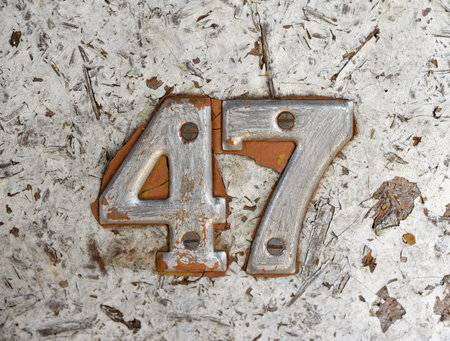 The old number plate on the apartment. Apartment number 47.の写真素材