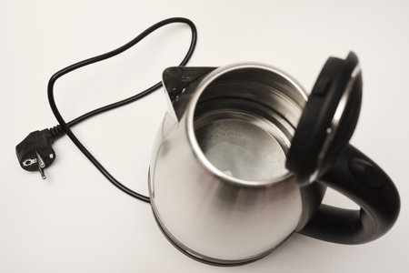 Electric kettle on a white background. A metal teapot with a black handle.の写真素材