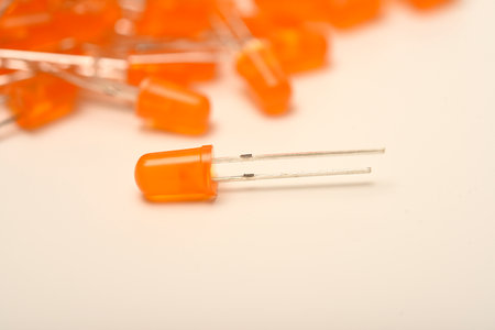 An orange LED on the background of a bunch of LED elements. One electronic LED.の写真素材