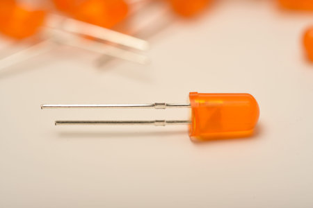 An orange LED on the background of a bunch of LED elements. One electronic LED.