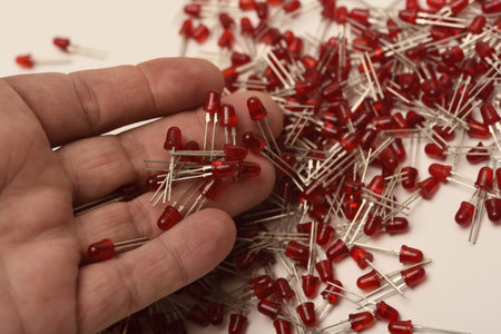 Red LED lights in your hand. Electronic LED element.