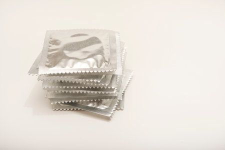 Condoms in shiny packaging on a white background.の写真素材
