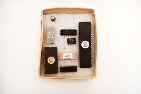 Several microcircuits on white foam. Old integrated circuits for radio electronics.
