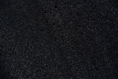 Background of porous foam rubber. Black foam rubber. Packaging material.の写真素材