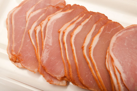 Cut the ham into thin slices.の写真素材