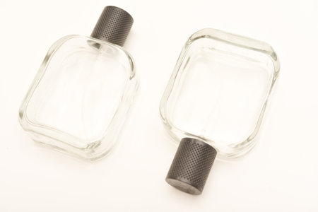 Empty glass perfume bottle. Elegant transparent bottle once filled with fragrance, now standing clean and minimalistic, ideal for cosmetics or beauty-related concepts.の写真素材