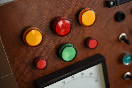 An old control board with a voltmeter, switches and lamps. Electronic control panel with buttons and...