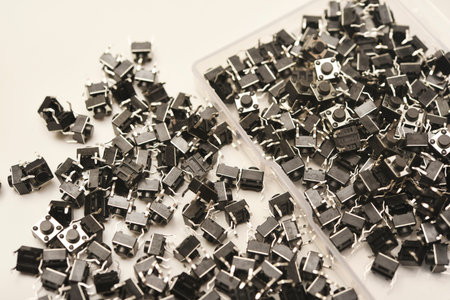 Black electronic buttons in a plastic container. Electronic elements.