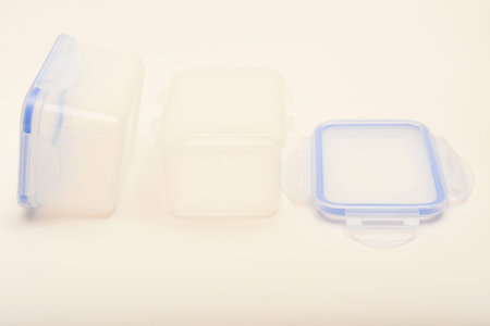 Small containers for food. Two plastic containers with a blue lid for food on a white background.