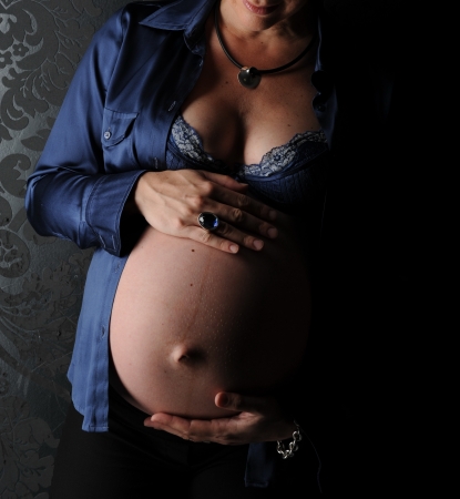 Young pregnant woman belly exposedの写真素材
