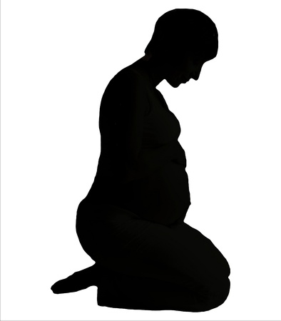 Young pregnant woman is kneeling silhouette on white backgroundの写真素材