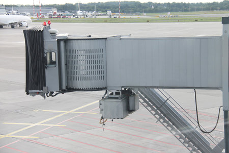 Airport  Landing field and gangway with aircrafts in the background
