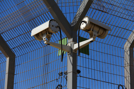 A secured industrial zone with Security camera on blue sky background