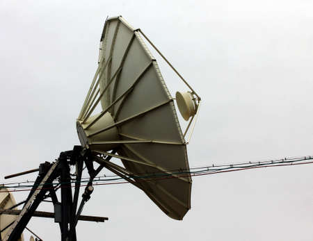 Satellite dish  at a winter sky backgroundの写真素材