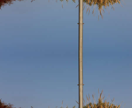 Empty pole  on blue sky backgroundの写真素材