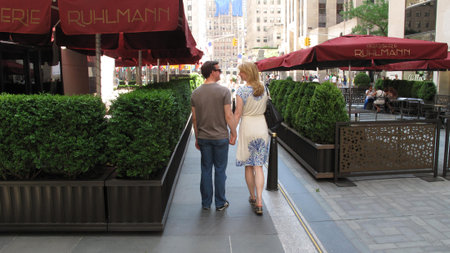  Manhattan at  first day of summer on June 01, 2013 in New York  A young couple walking down the street holding handsのeditorial素材