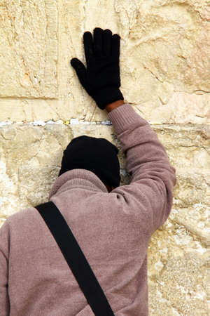 Jewish worshiper prays at the Wailing Wall an important jewish religious site at winter  Jerusalem, Israelのeditorial素材