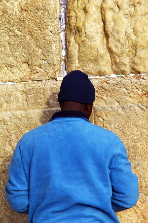 Jewish worshiper prays at the Wailing Wall an important jewish religious site at winter Jerusalem, Israelのeditorial素材