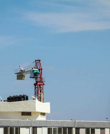 Setting up a tower crane in the construction site.  The counter jib is installed.
