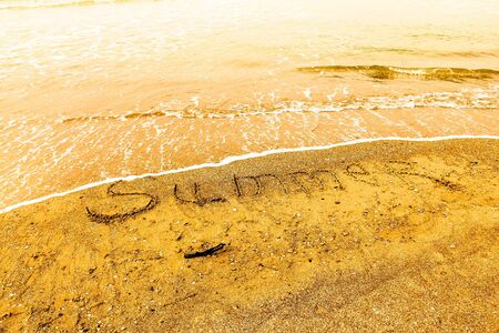 Inscription beach sand Summer. Concept photo of summer travel and vacation.の写真素材
