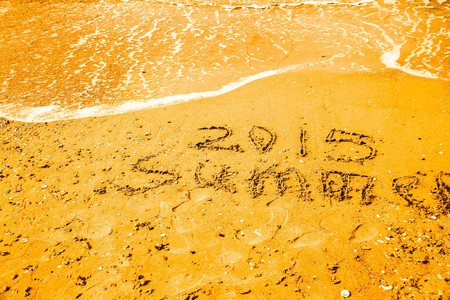 Inscription beach sand Summer 2015. Concept photo of summer travel and vacation.の写真素材
