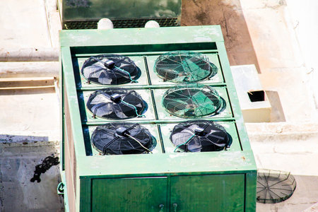 Old ventilation system on the roof of an industrial buildingの写真素材