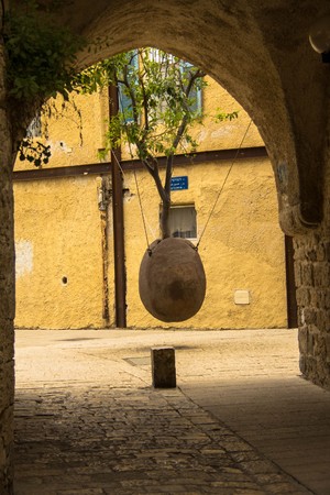 Orange tree in stone vessel levitating in the courtyard at  old city Jaffa . Israelの写真素材