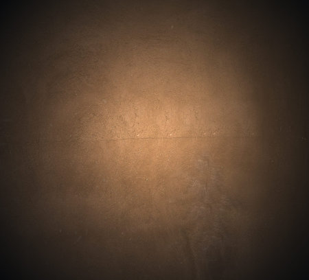 Brown painted  plaster pattern  background with spotlight and  place for your design or textの写真素材