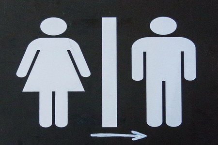 Toilet sign  and diraction on black metal shieldの写真素材