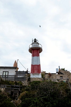 Old Jaffa lighthouse at cloudy spring day, Israelの写真素材